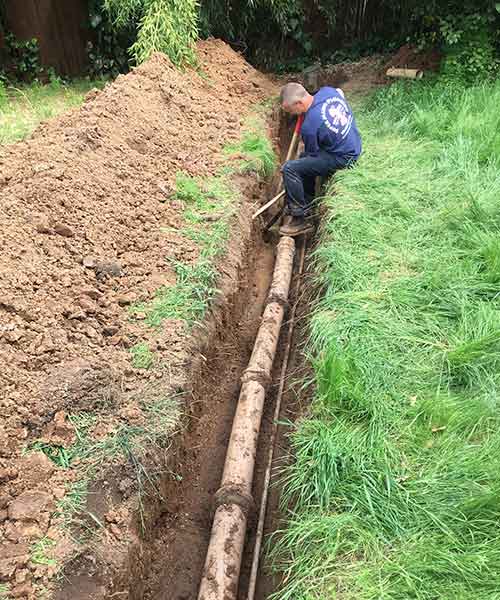 when a section of the pipe has sunk into the ground, creating an area for waste to converge.